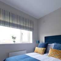 This bedroom features a roman blind in our ever-popular Audrey Stripe fabric.